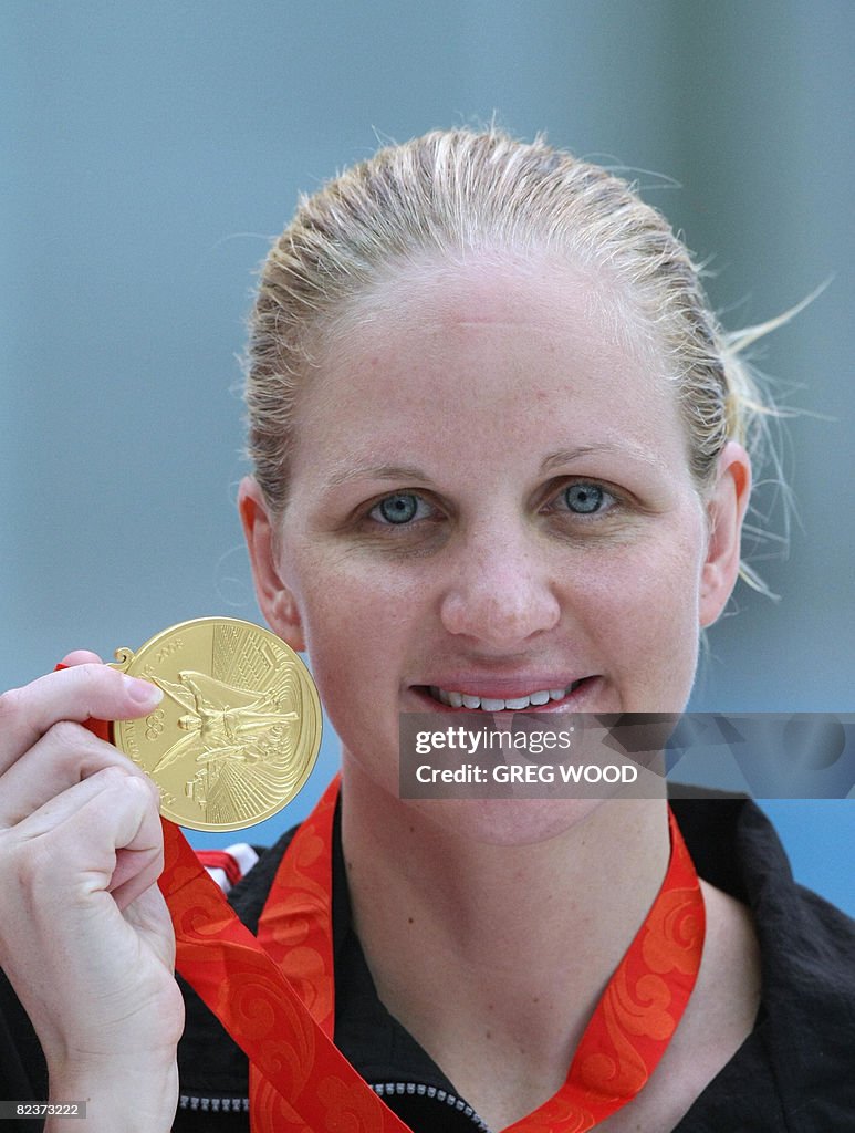 Zimbabwe's Kirsty Coventry stands on the