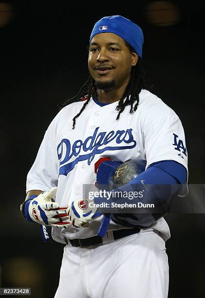 Manny Ramirez of the Los Angeles Dodgers smiles as he waits between innings of the game against the Milwaukee Brewers on August 15, 2008 at Dodger...