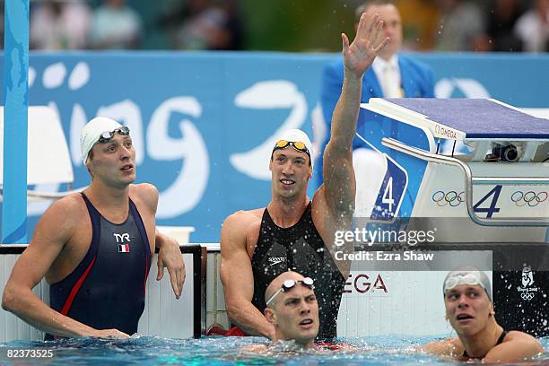 Amaury Leveaux of France, Alain Bernard of France, Ashley Callus of Australia and Cesar Cielo Filho of Brazil check their times after competing in...