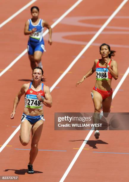 Russia's Evgeniya Polyakova runs to win the women's 100m heat 9 at the National stadium as part of the 2008 Beijing Olympic Games on August 16, 2008....