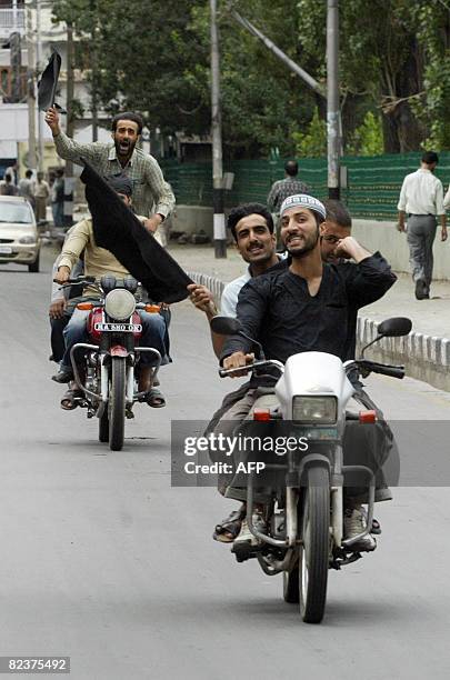 Indian Kashmiri Muslims carry Islamic and black flags during a protest rally towards the home town of slain separatist leader Sheikh Abdul Aziz, in...