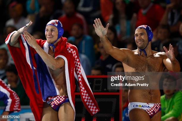 The Croatian team celebrate from the bench during the Mens Waterpolo Semi-final match against Serbia on day fourteen of the Budapest 2017 FINA World...