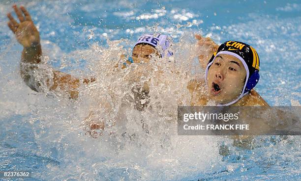 Junmin Xie of China clashes with Vanja Udovicic of Serbia in their men's preliminary round group B water polo match of the 2008 Beijing Olympics...