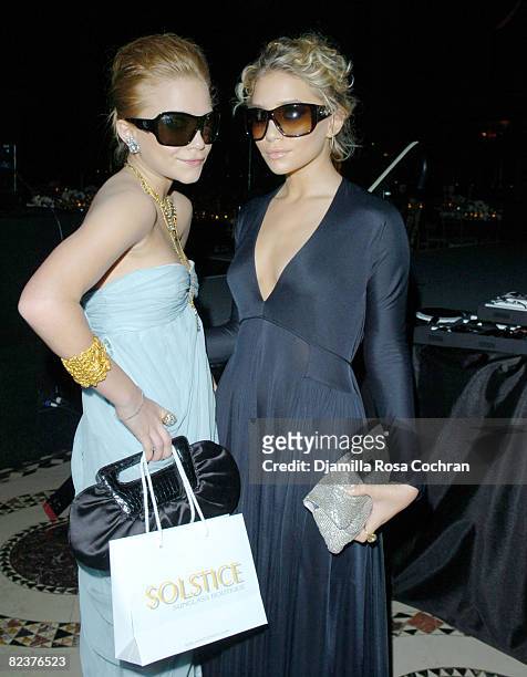 Mary Kate Olsen wearing Alexander McQueen 4025S Sunglasses and Ashley Olsen wearing Yves Saint Laurent 6112S Sunglasses