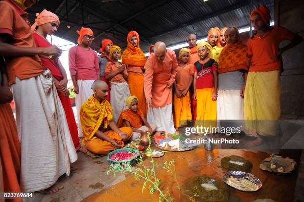 Nepalese kids from Hindu school Bhagwat Sanyaas Aashram Gurukul performing rituals offering during Nag Panchami festival at Pashupatinath Temple,...