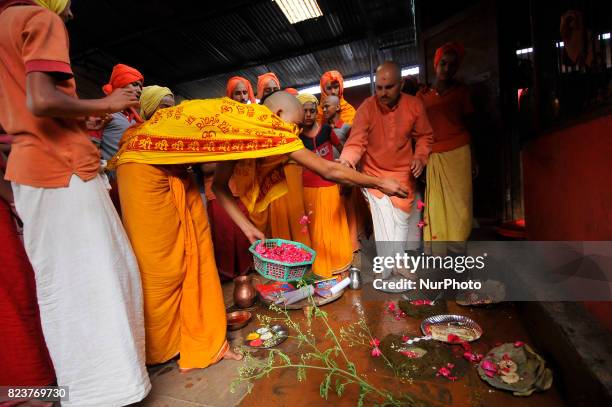 Nepalese kids from Hindu school Bhagwat Sanyaas Aashram Gurukul performing rituals offering during Nag Panchami festival at Pashupatinath Temple,...