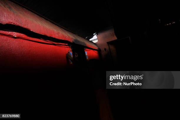 Nepalese kids from Hindu school Bhagwat Sanyaas Aashram Gurukul sticks a picture of a snake god at the main entrance during Nag Panchami festival at...