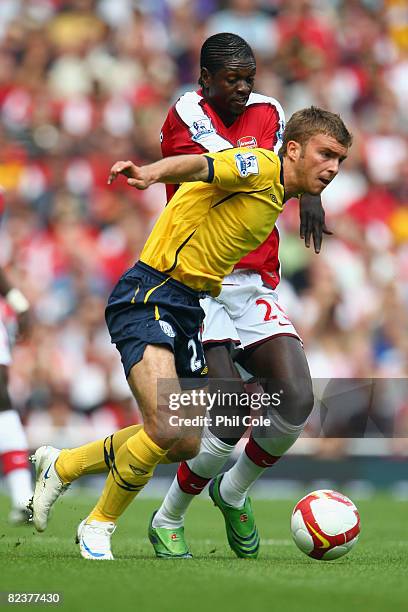 James Morrison of West Bromwich Albion battles for the ball with Emmanuel Adebayor of Arsenal during the Barclays Premier League match between...