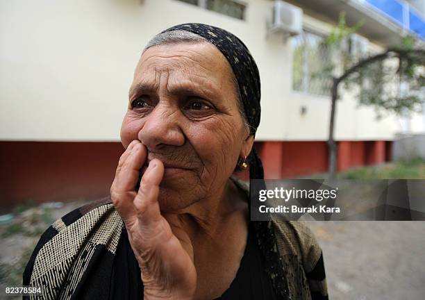 Woman touches her face on August 16, 2008 near the village of Igoeti on the road from Gori to Tbilisi, about 45 kilometres from Tbilisi, Georgia....