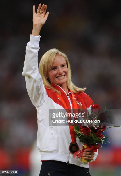 Athlete Shalane Flanagan poses with her bronze medal on the podium for the women's 10,000m final at the National stadium as part of the 2008 Beijing...