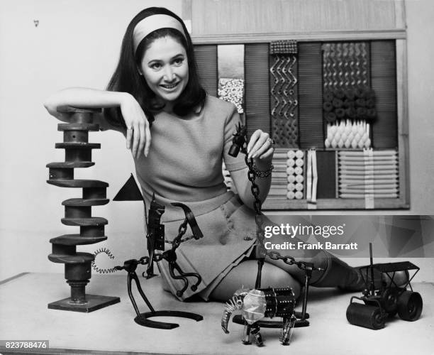 English television presenter Jan Leeming with some of the pieces of 'instant art' on the BBC children's programme 'Tom Tom', at the BBC TV Centre in...