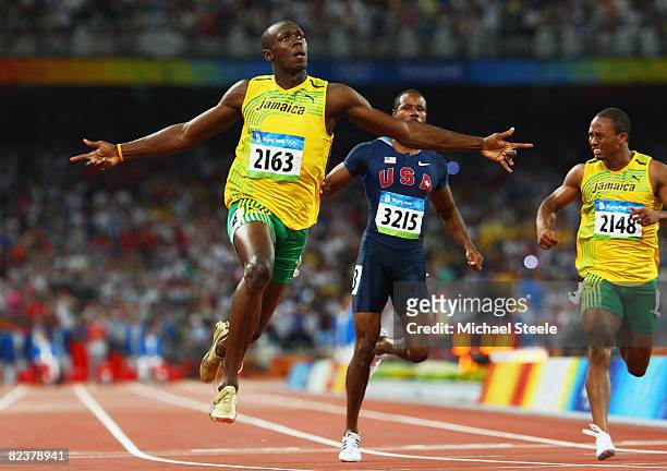 Usain Bolt of Jamaica celebrates as he crosses the line in the Men's 100m Final at the National Stadium on Day 8 of the Beijing 2008 Olympic Games on...