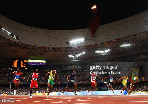 Usain Bolt of Jamaica celebrates crossing the line in the Men's 100m Final at the National Stadium on Day 8 of the Beijing 2008 Olympic Games on...
