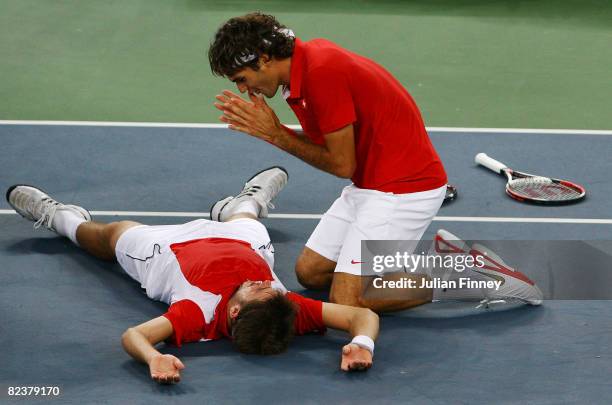 Roger Federer and Stanislas Wawrinka of Switzerland celebrate after defeating Thomas Johansson and Simon Aspelin of Sweden during the men's doubles...