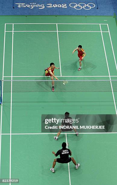 He Hanbin and Yu Yang of China play against Nova Widianto and partner Liliyana Natsir of Indonesia in the mixed doubles semi-final of the badminton...