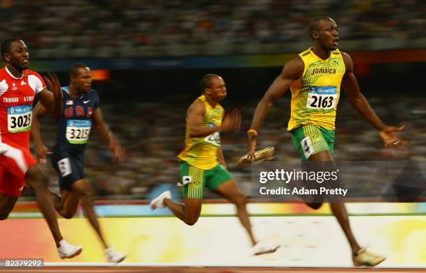 Usain Bolt of Jamaica celebrates as he approaches the line on his way to winning the Men's 100m Final at the National Stadium on Day 8 of the Beijing...