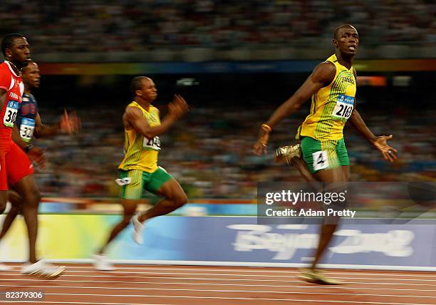 Asafa Powell of Jamaica and Usain Bolt of Jamaica compete in the Men's 100m Final at the National Stadium on Day 8 of the Beijing 2008 Olympic Games...