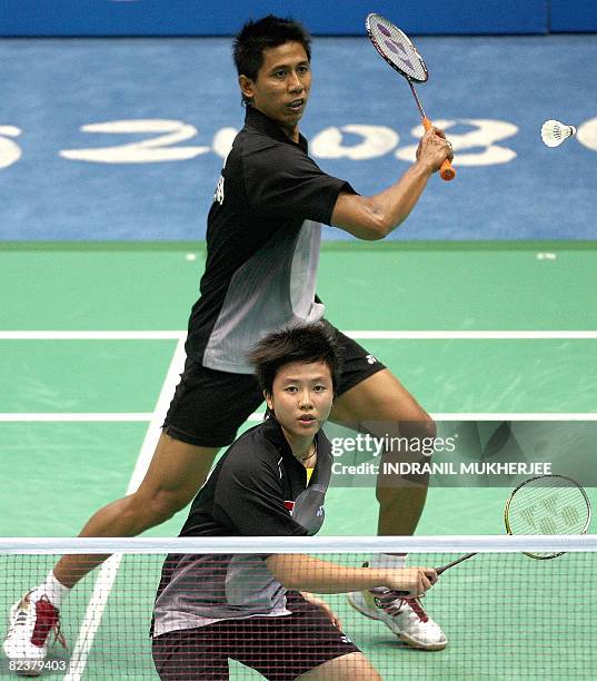 Nova Widianto and Liliyana Natsir of Indonesia play against He Hanbin and Yu Yang of China in the mixed doubles semi-final of the badminton event...