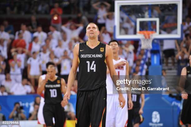 Dirk Nowitzki of Germany looks at the score during the group B preliminary basketball game at the Beijing Olympic Basketball Gymnasium on Day 8 of...