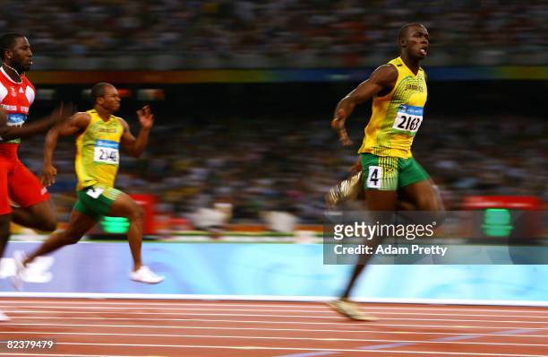 Usain Bolt of Jamaica celebrates as he approaches the line on his way to winning the Men's 100m Final at the National Stadium on Day 8 of the Beijing...