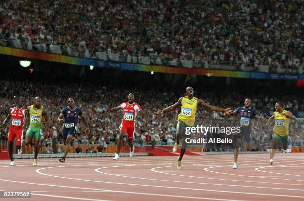Usain Bolt of Jamaica celebrates as he crosses the line to win the Men's 100m Final at the National Stadium on Day 8 of the Beijing 2008 Olympic...