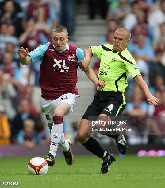 Freddie Sears of West Ham United and Lee Cattermole of Wigan Athletic in action during the Barclays Premier League match between West Ham United and...