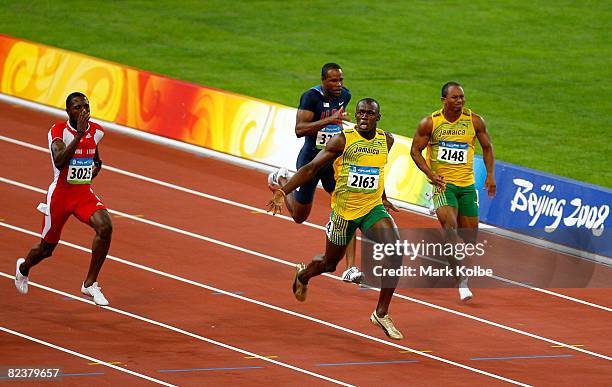 Usain Bolt of Jamaica celebrates as he approaches the line on his way to winnig the Men's 100m Final at the National Stadium on Day 8 of the Beijing...
