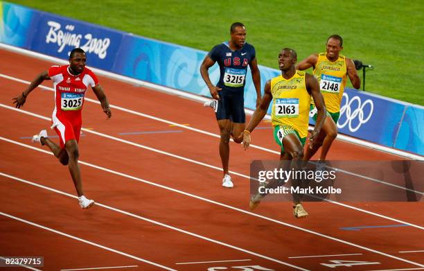 Usain Bolt of Jamaica celebrates as he approaches the line on his way to winnig the Men's 100m Final at the National Stadium on Day 8 of the Beijing...