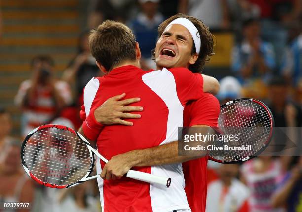 Roger Federer and Stanislas Wawrinka of Switzerland celebrate after defeating Thomas Johansson and Simon Aspelin of Sweden during the men's doubles...