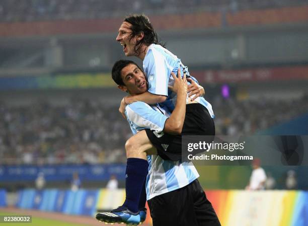 Lionel Messi of Argentina celebrates the first goal with teammate Angel Di Maria during the Men's Quarter Final match between Argentina and...