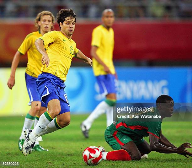 Deigo of Brazil and Gustave Bebbe of Cameroon compete for the ball during the Men's Quarter Final match between Brazil and Cameroon at Shenyang...