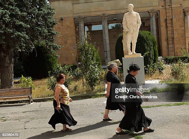 Women walk past a statue of Josef Stalin August 16, 2008 in Gori, Georgia. Gori is the birthplace of Josef Stalin, and has several statues of him and...