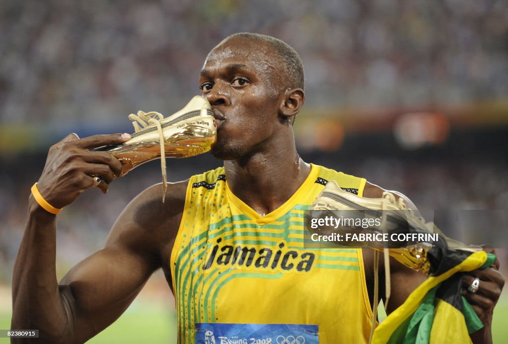 Jamaica's Usain Bolt kisses his shoe aft