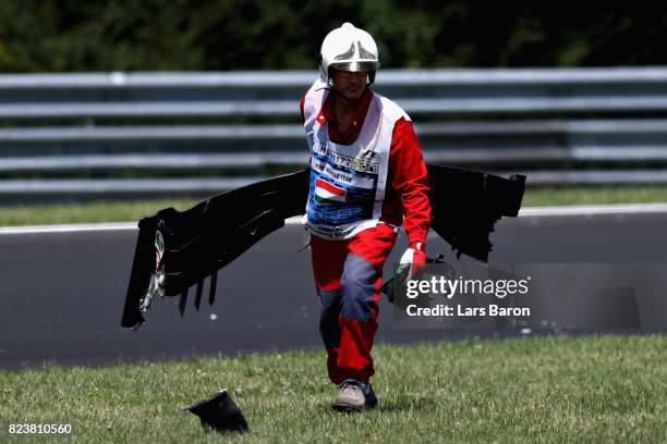 Marshal removes the front wing of Antonio Giovinazzi of Italy and Haas F1 from the circuit during practice for the Formula One Grand Prix of Hungary...