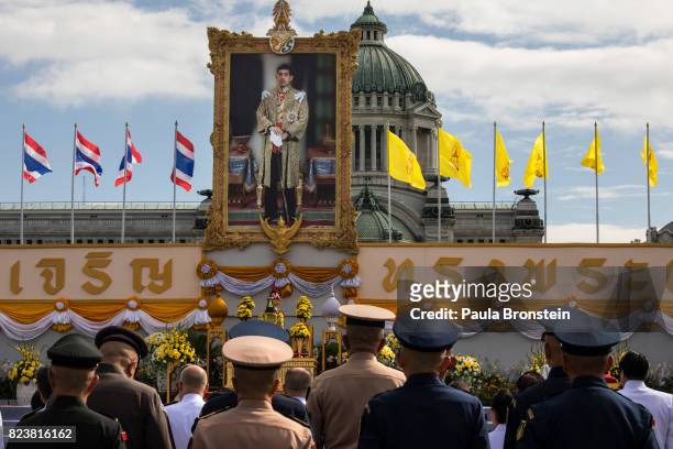 Thai palace officials and military stand at attention at the Royal palace gathering for Merit-making ceremonies as Thai people celebrate the 65th...