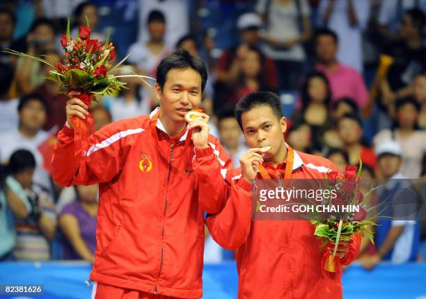 Markis Kido and Hendra Setiawan of Indonesia celebrate with their gold medals in the men's badminton doubles event of the 2008 Beijing Olympic Games...
