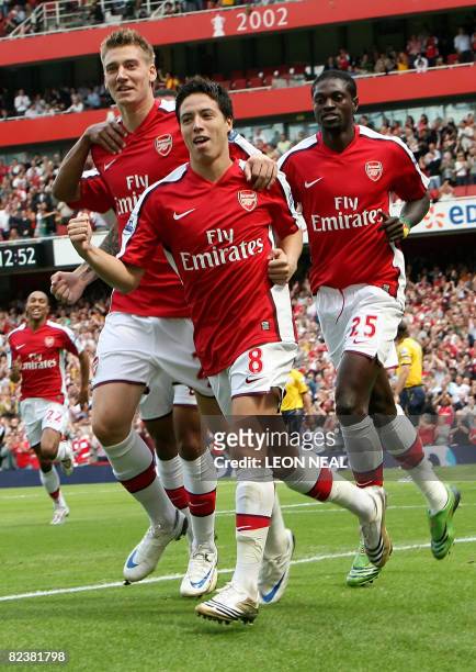 Arsenal's French player Samir Nasri celebrates his early goal against West Bromwich Albion during the first match of the new season at the Emirates...