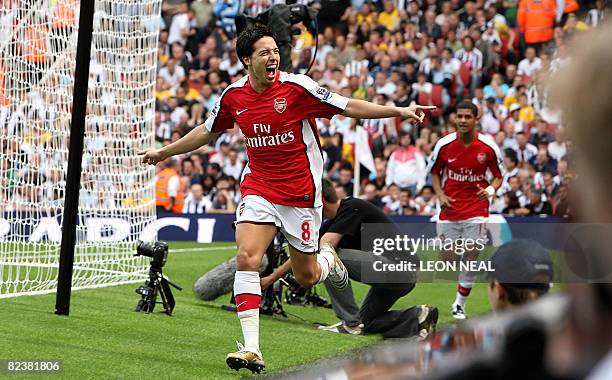 Arsenal's French player Samir Nasri celebrates his early goal against West Bromwich Albion during the first match of the new season at the Emirates...