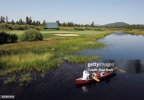 Canoe of visitors meander along the Little Deschutes River paddling past the 18th green during the third round of the JELD-WEN Tradition held at...