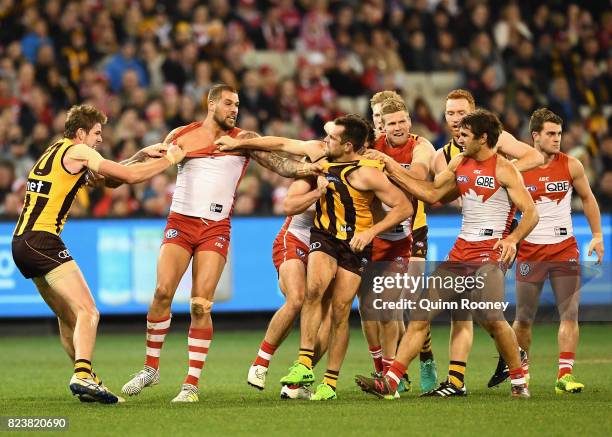 Lance Franklin of the Swans and Luke Hodge of the Hawks push and shove during the round 19 AFL match between the Hawthorn Hawks and the Sydney Swans...