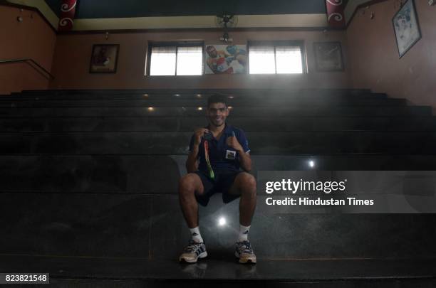 National Boxing Medallist and four-time state gold medallist Akshay Mare poses for photo with his bronze medal at Lahuji Vastad Salve Boxing Training...