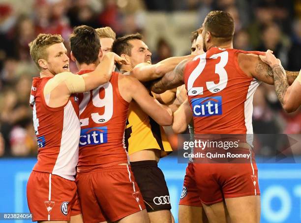 Lance Franklin of the Swans and Luke Hodge of the Hawks push and shove during the round 19 AFL match between the Hawthorn Hawks and the Sydney Swans...