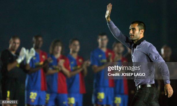 Barcelona's coach Josep Guardiola waves to his fans as his players applaud during an official presentation in their 43th Trophy Joan Gamper friendly...