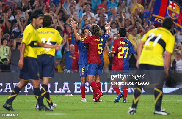 Barcelona's captain Carlos Puyol is congratuled by his teammate Xavi Hernandez after scoring during their 43th Trophy Joan Gamper friendly football...
