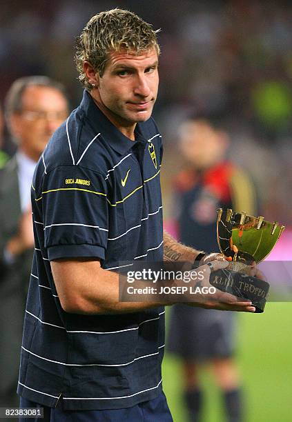 Argentina 's Boca Juniors Palermo poses with a trophy after their 43th Joan Gamper friendly football match against Barcelona at Camp Nou stadium in...