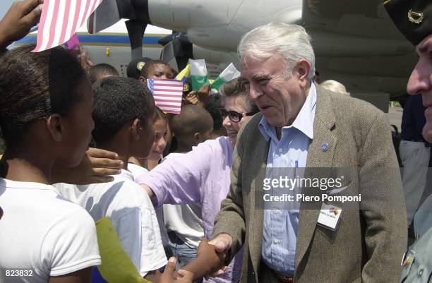 Former US House International Relations Committee Chairman Benjamin Gilman greets children as he arrives in Cartagena, Colombia February 17, 2001...