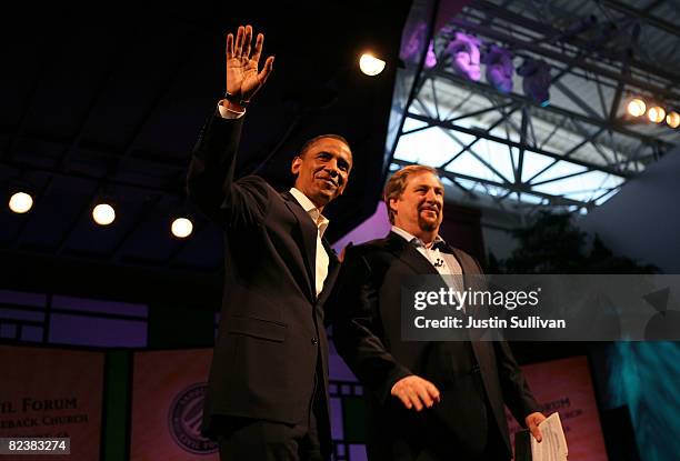 Presumptive Democratic Presidential candidate U.S. Sen. Barack Obama waves to the crowd with pastor Rick Warren before the start of the Civil Forum...