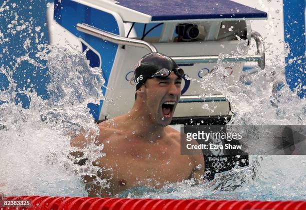 Michael Phelps of the United States celebrates victory in the Men's 100m Butterfly Final held at the National Aquatics Centre during Day 8 of the...