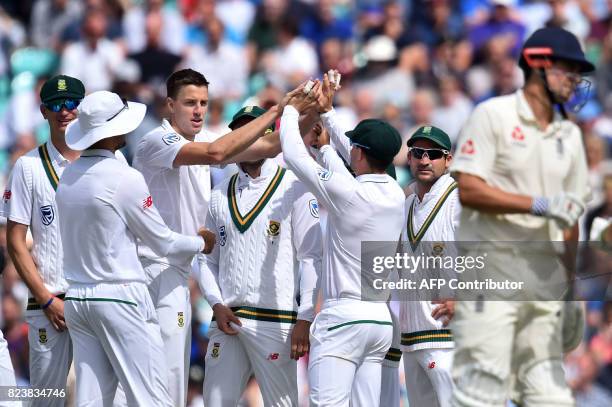 South Africa's Morne Morkel celebrates, with teammates, the wicket of England's Alastair Cook for 88 on the second day of the third Test match...