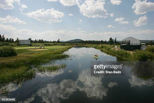 Canoe of visitors meander along the Little Deschutes River paddling past the 18th green during the third round of the JELD-WEN Tradition held at...